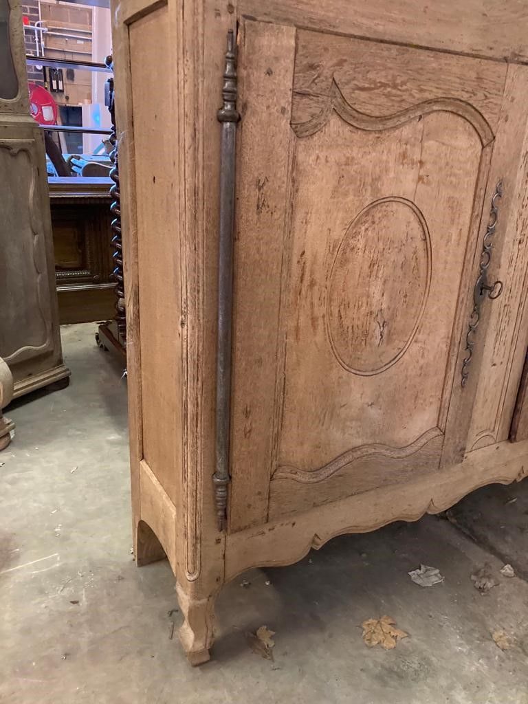 A late 18th century French provincial bleached oak three door buffet, length 244cm, depth 46cm, height 133cm